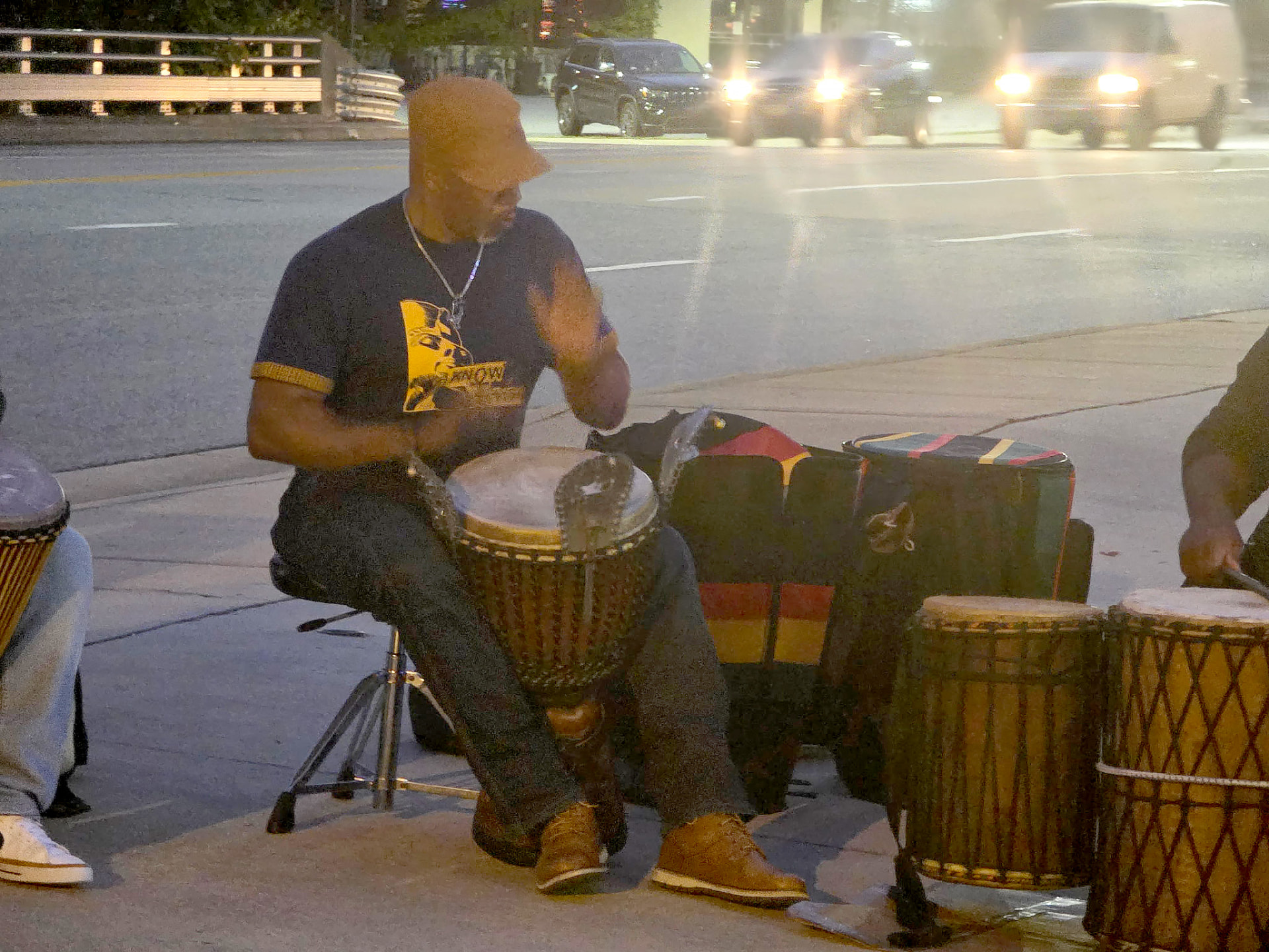 Djembe drummer playing outside Saint Louis Saveurs at night